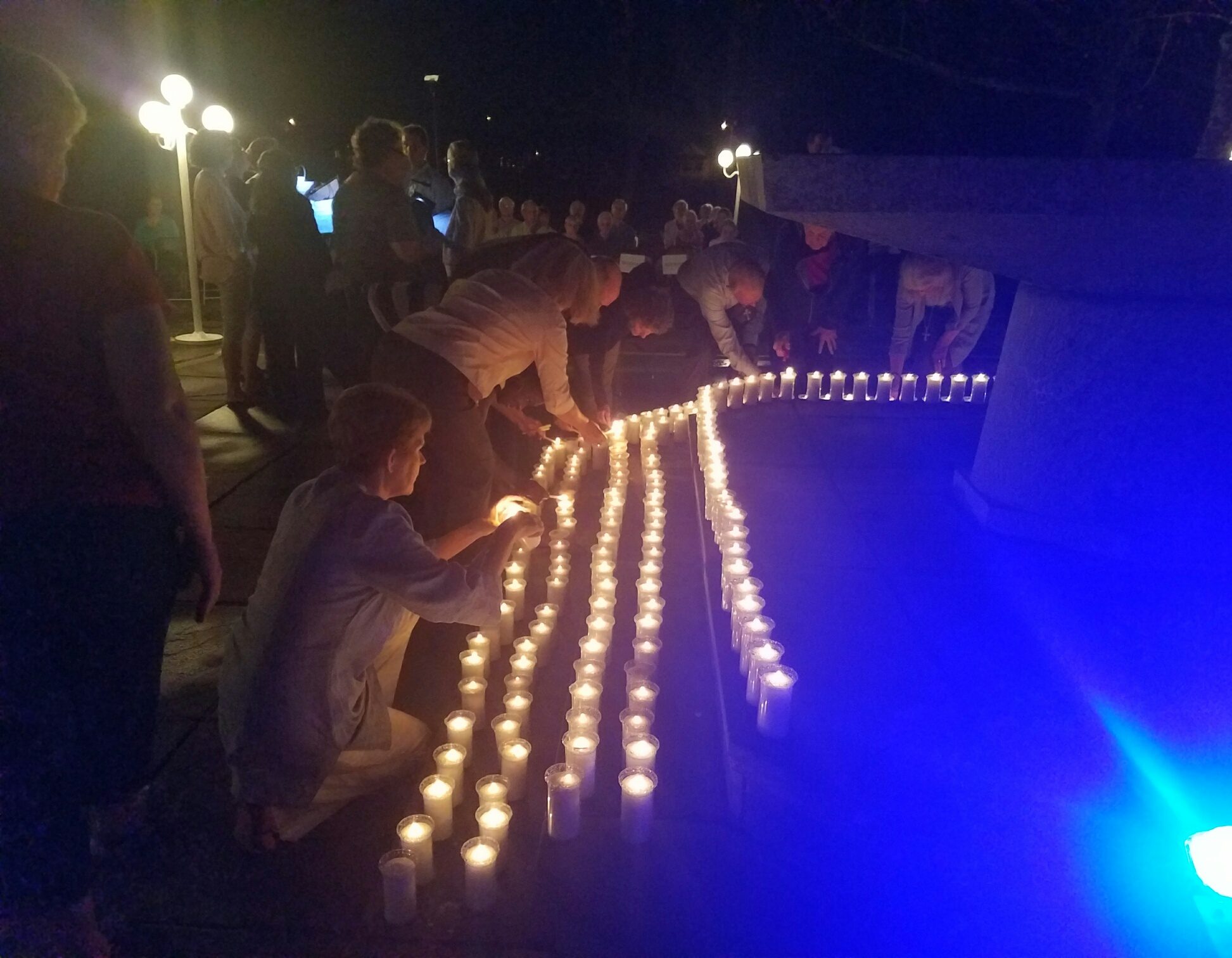 Event participants help light 386 candles, one for each person on Florida's death row.