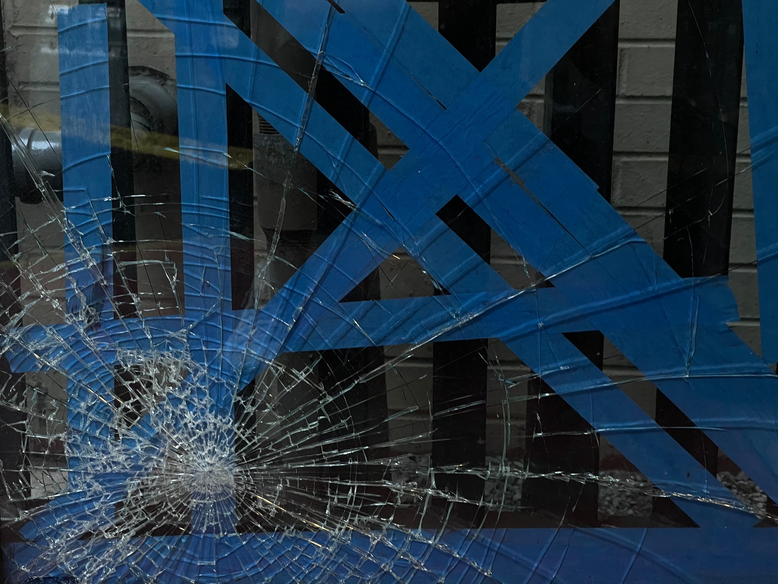 broken glass with blue tape on it