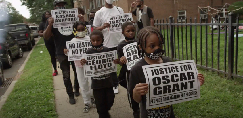 A scene from the video for "8Min46Secs." The HUBB