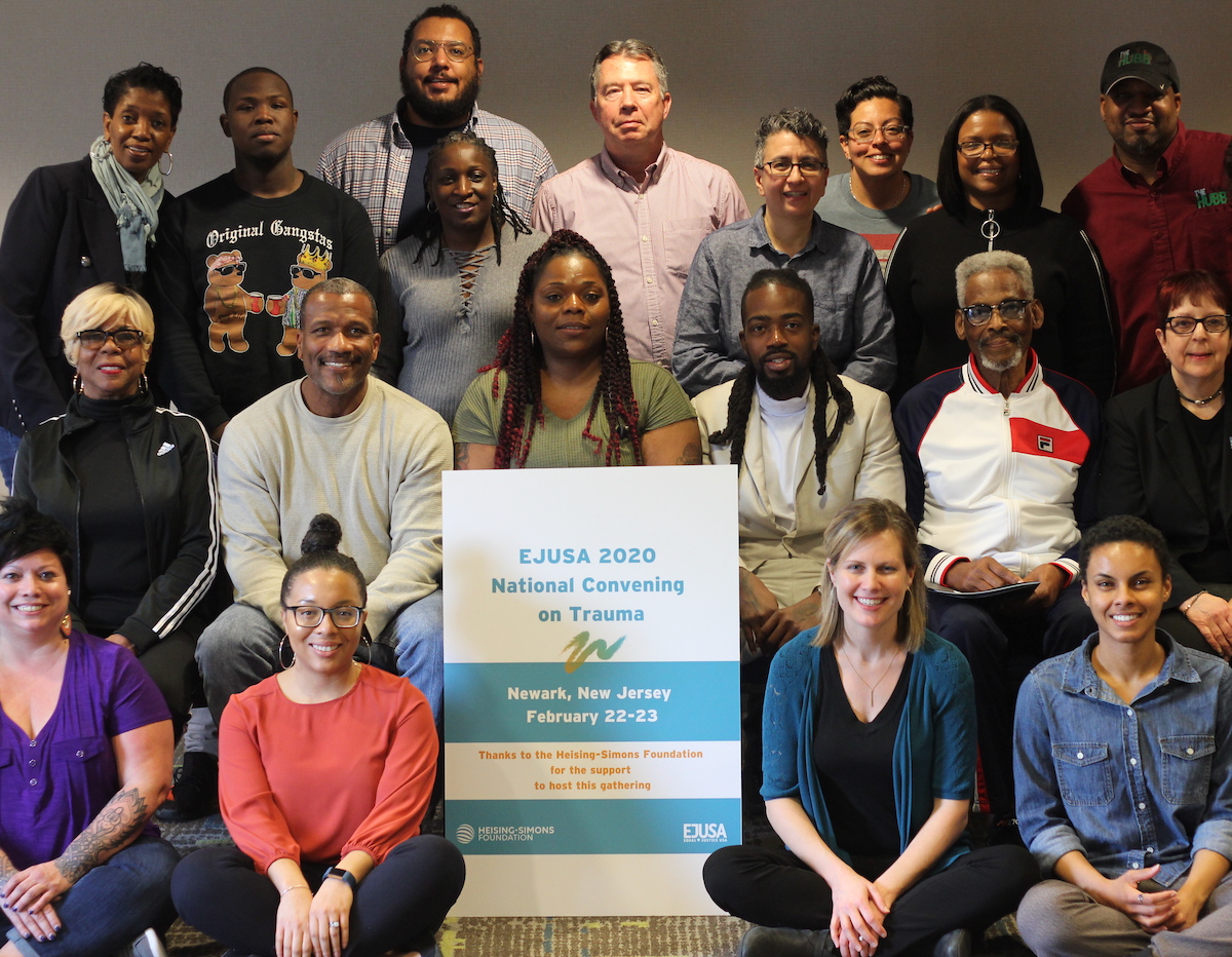 Members of EJUSA's staff and Trauma Healing Network are gathered, smiling at the camera