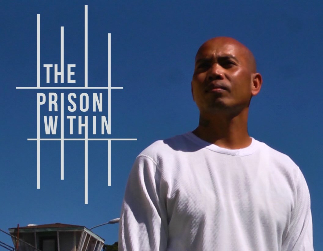 A poster for the film "A Prison Within". A man with a shaved head stands in front of a prison, looking up toward the sky. He is wearing a long sleeved white shirt.