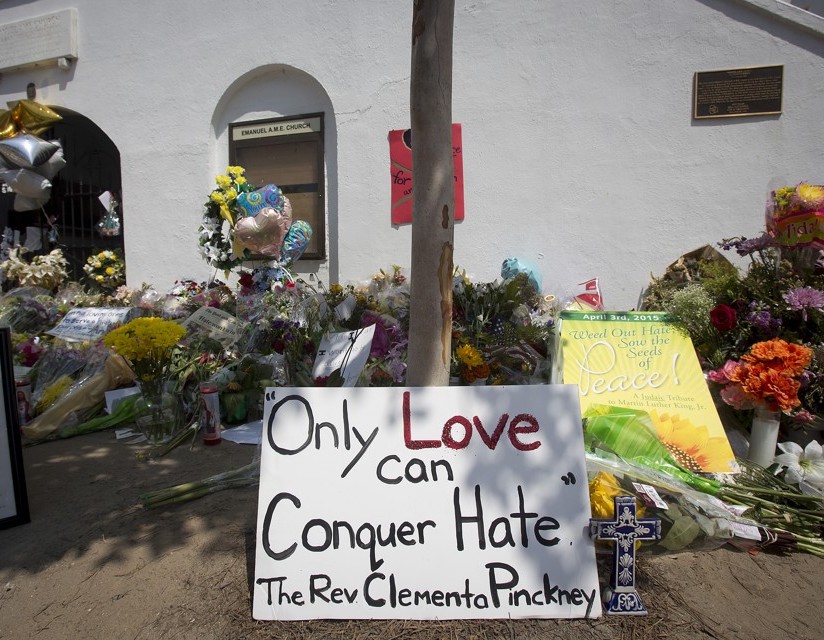 A sign is pictured at a makeshift memorial for victims of a mass shooting, outside the Emanuel African Methodist Episcopal Church in Charleston, June 22, 2015.