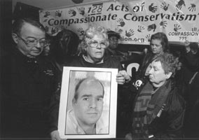 Lois & Ken Robinson hold a photo of their mentally-ill son Larry during his execution at Huntsville, TX, on January 21.